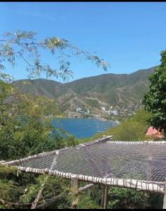 a view of a body of water with mountains in the background at Hostal Casa Horizonte in Taganga