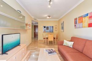 a living room with a couch and a tv at Star City in Málaga