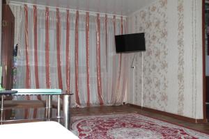 a living room with a tv on the wall at Монтана in Petropavlovsk