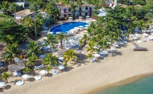 an aerial view of a beach with chairs and umbrellas at DPNY Beach Hotel & SPA Ilhabela in Ilhabela