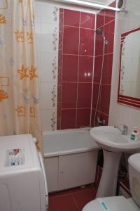 a bathroom with a sink and a tub and a toilet at Монтана in Petropavlovsk