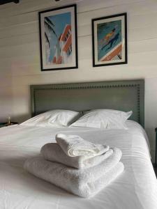 een bed met witte handdoeken erop bij Loft sur les toits de Roubaix in Roubaix