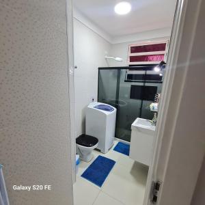a bathroom with a toilet and a glass shower at Apartamento Sandy-Zona Sul in Rio de Janeiro