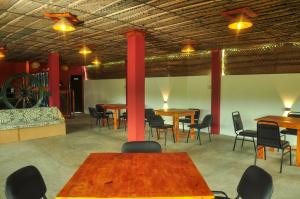a dining room with tables and chairs and a wheel at Airport Tourist Resort in Katunayake