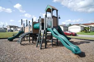 a row of slides in a playground at J's Family Vacation Low Maid Fee in Davenport