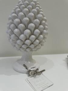 a vase filled with white balls on a table at Ines bed and breakfast & Apartments in Giardini Naxos