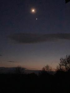 uma vista da lua no céu à noite em The Dragon's Hut with pool now open em Wrexham