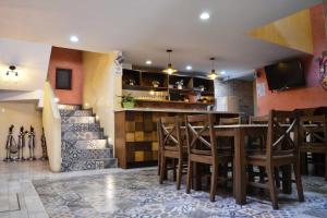 a restaurant with a table and chairs and a bar at Hotel Boutique Casa Abuela Maria in Oaxaca City +23 photos