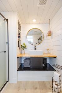 a bathroom with a sink and a mirror at Zion Tiny Home, Hot Tub, Gooseberry Mesa Trails in Apple Valley