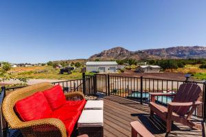 a deck with a red couch and chairs on it at Lil' Blue Oasis Tiny Home in Apple Valley