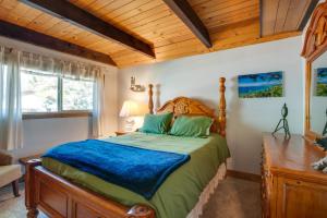 a bedroom with a bed and a wooden ceiling at Rustic Lake Tahoe Cabin with Pool Table and Deck! in South Lake Tahoe