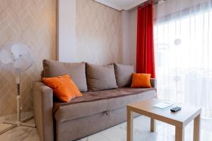 een woonkamer met een bank en een tafel bij Beautiful, quiet apartment with heated pool AP236 in San Miguel de Abona
