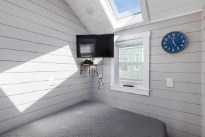 a room with a clock and a window at Royal sands tiny home in Apple Valley