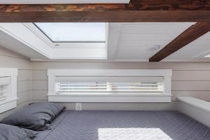 a bedroom with a bed and a skylight at Royal sands tiny home in Apple Valley