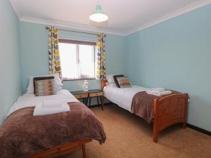 a bedroom with two beds and a window at Beach Haven in Norwich