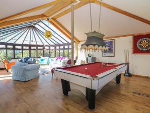 a living room with a pool table in a room at Beach Haven in Norwich