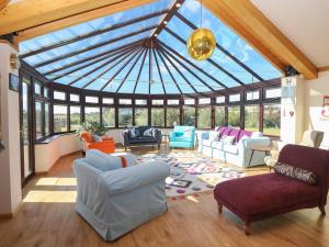 a living room with a conservatory with a glass ceiling at Beach Haven in Norwich