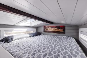 a large bed in a bedroom with a ceiling at Zen Tiny Home in Apple Valley