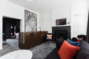 a living room with a couch and a fireplace at Welcome London Soho in London
