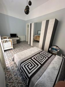 a bedroom with a bed and a crib in it at Elisir house in Palermo