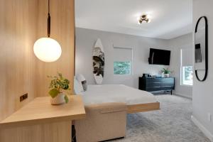 a bedroom with a bed and a desk and a tv at The St Laurent Guest Rooms in Asbury Park