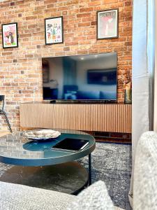 un soggiorno con tavolo e TV di Red Rock Apartments - mit Parkplatz, Küche und Netflix a Treviri