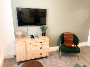 a living room with a chair and a television on a dresser at Charming 1BR Apartment in Nottingham in Nottingham