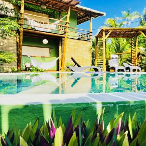 a villa with a swimming pool and a house at Maui Maui Wellness- Taipu de Fora in Barra Grande