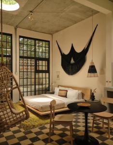 a bedroom with a bed and a table and chairs at PAZ by DW in San Juan