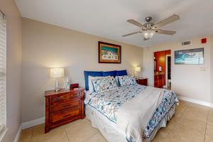 a bedroom with a bed and a ceiling fan at Sand and Sea Enjoyment Retreat in Ormond Beach