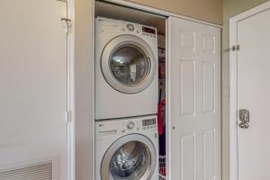 a laundry room with a washer and dryer at Sand and Sea Enjoyment Retreat in Ormond Beach
