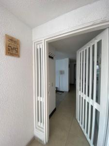 an empty room with a hallway with a sign on the wall at Hostel Urban City Bogotá in Bogotá