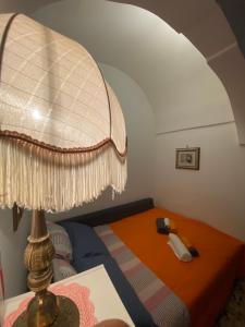 a bedroom with a bed with a lamp on it at TumHouse (la capanna di zio Tom) in Ceglie Messapica