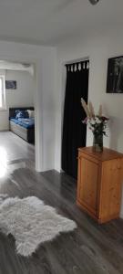 a living room with a vase of flowers on a table at Gemütliche 5Pers Ferienwohnung "Am Steinbach" Nähe Nürnberg Ruhig und gute Anbindung in Burgthann