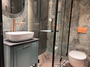 a bathroom with a sink and a shower at PALACE of the Dead Sea by CROWN Exclusive in Neve Zohar