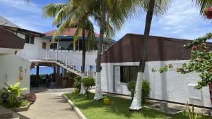 a building with palm trees in front of it at On Vacation Blue Reef in San Andrés