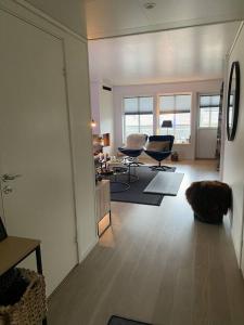 a living room with two chairs and a table at Charming apartment in Meråker in Meråker