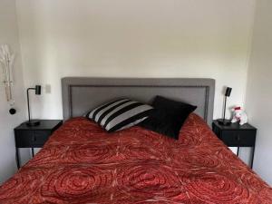 a bed with two pillows on top of it at Charming apartment in Meråker in Meråker