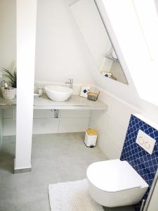 a bathroom with a toilet and a sink at Villa Miód Malina -Wisełka in Wisełka