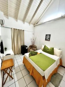 a bedroom with a bed and a chair in a room at E.W.B. Properties in Basse Terre Town