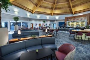 a lobby with couches and tables and a bar at Delta Hotels by Marriott Waltham Abbey in Waltham Abbey