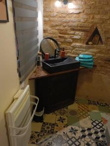 a bathroom with a sink and a mirror at La lauze et l'anguille in Gaillac