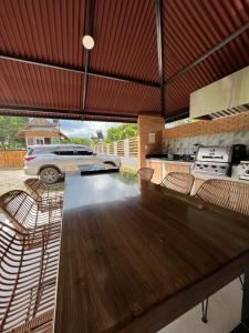 a kitchen with a large wooden table and chairs at cabañas BORA BORA Villavicencio in Villavicencio +4 photos