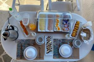 a toy table with food on top of it at Blue Dolphin Studios and Apartment in Vaia