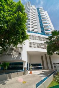 a large white building with two tall buildings at Unik Cartagena Edificio Poseidon in Cartagena de Indias