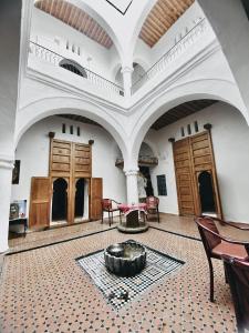 a large room with a table and chairs in it at Tarbi'aat Tetaoun 44, 17th century heritage in Tetouan