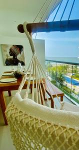a hammock in a room with a table and a window at morros epic luxury in Cartagena de Indias