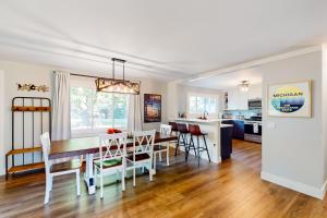 a dining room and kitchen with a table and chairs at Sleeping Bear in Empire