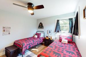 a bedroom with two beds and a ceiling fan at Sleeping Bear in Empire