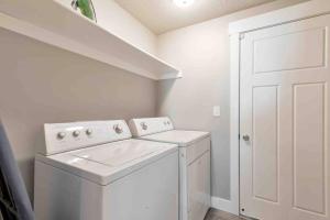 a white laundry room with a washer and dryer at Sleepy Ridge Apt in Vineyard/Orem (Sleeps 6) in Orem